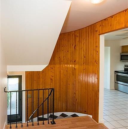 Unique curved stairway leads to main level.