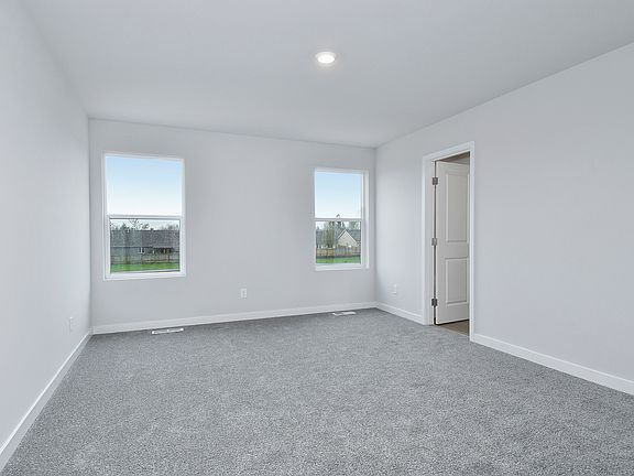 The master bedroom is spacious with two large windowsl