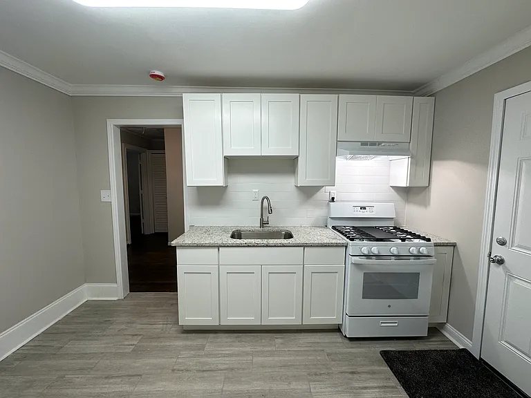 Kitchen with cabinets and stove in view