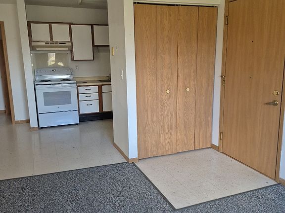 Looking into kitchen from living room. Entry and closet are to the right