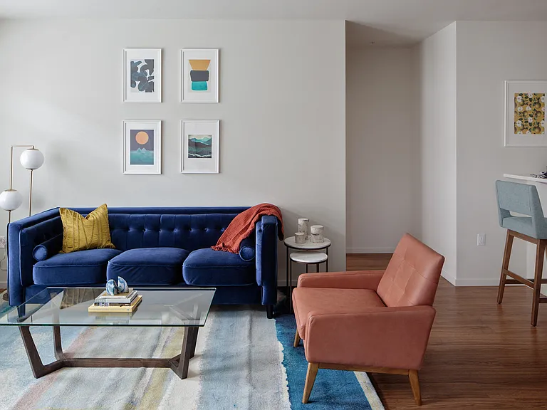 Grant Park village shot of coffee table and blue couch and orange chair