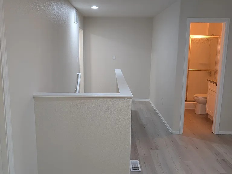 upstairs gathering area with second bathroom, and laundry room access