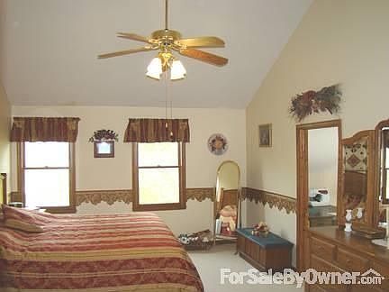 Master bedroom with cathedral ceiling.
