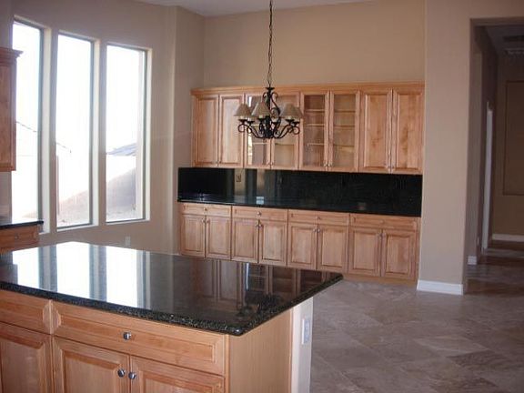 An eating area surrounded by granite counters.