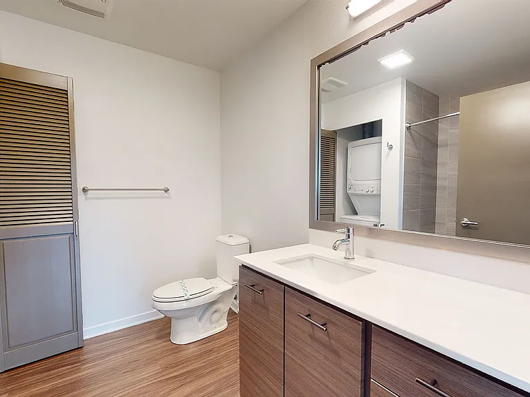 Apartment Bathroom with large soaking tub and Wood-Style Flooring..