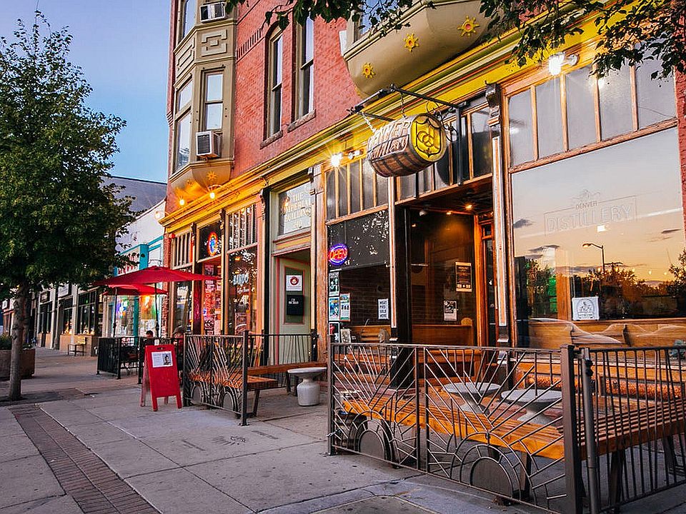 Experience the lively atmosphere of city life with charming storefronts and cozy outdoor dining.