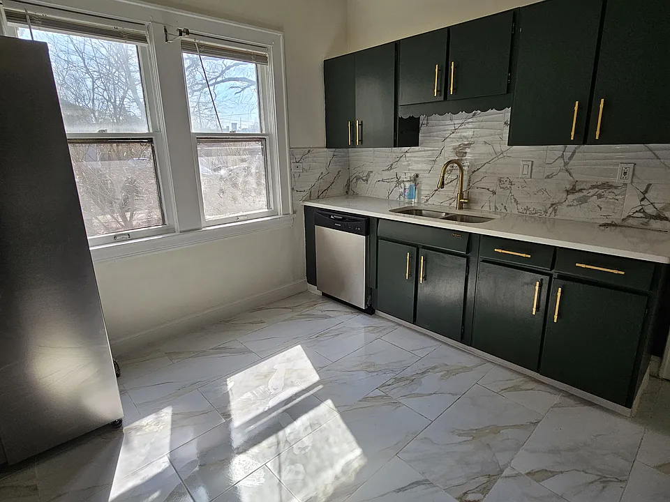 Beautifully remodeled kitchen with marble tile floors, quartz countertop and brand new appliances