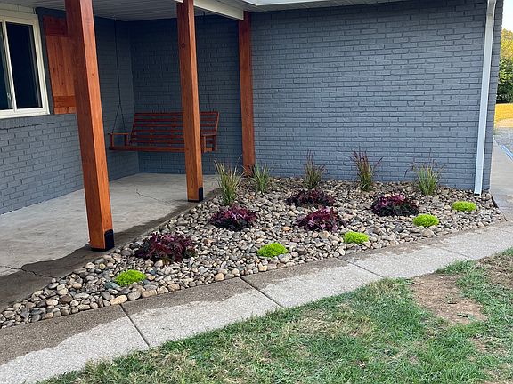 New landscaping in front of covered porch