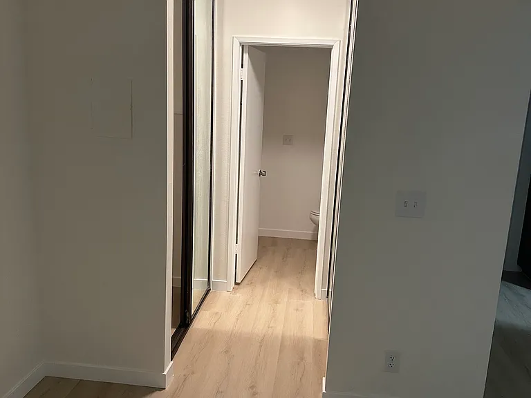 Mirrored closet doors, on the way to bathroom
