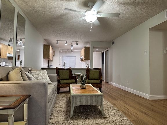 Living room looking back toward kitchen with eat-up breakfast nook.