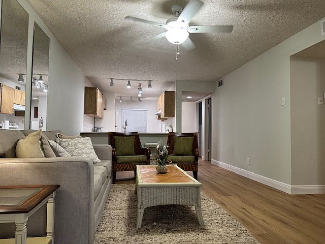Living room looking back toward kitchen with eat-up breakfast nook.
