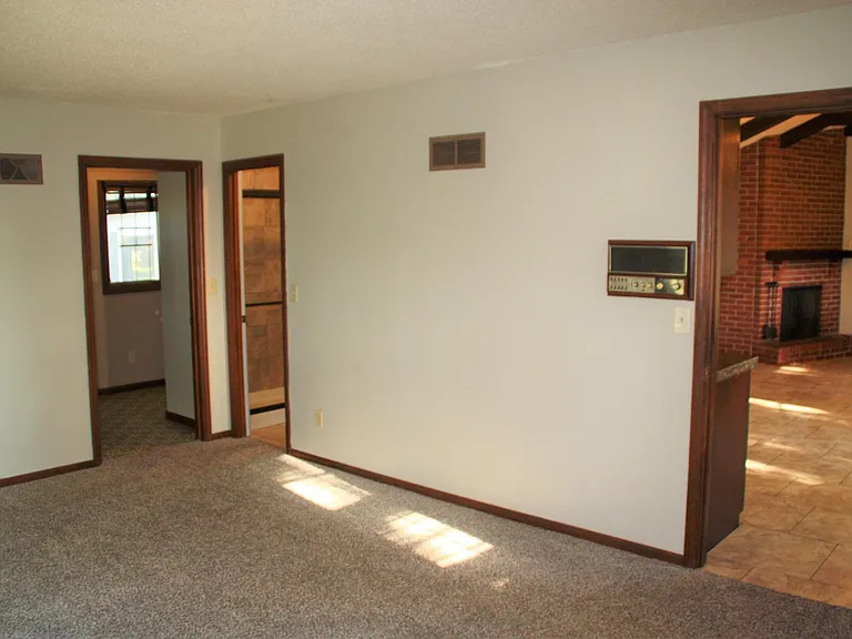 Primary bedroom off kitchen with Large walk-in closet. Ensuite bathroom with dual vanities and shower. Additional door is mud room entry with laundry hookups- also has rear entry near screened porch.