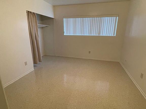 Master bedroom with new window blinds and ceiling fan. Leads to a 3/4 bath with granite counter top.