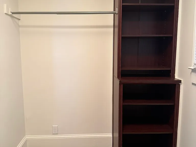 Upstairs primary closet cabinet + clothing rod.