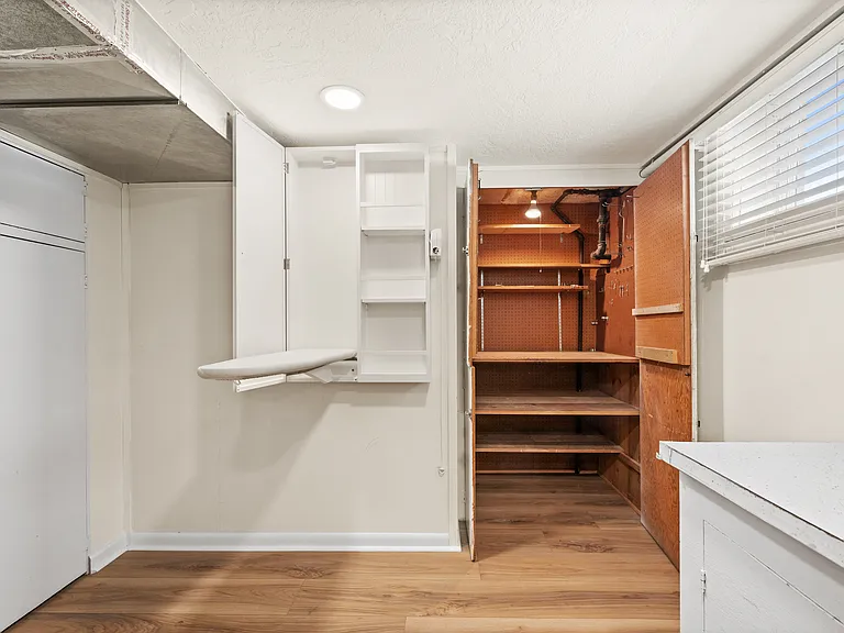 Laundry room with tons of storage space and ironing board