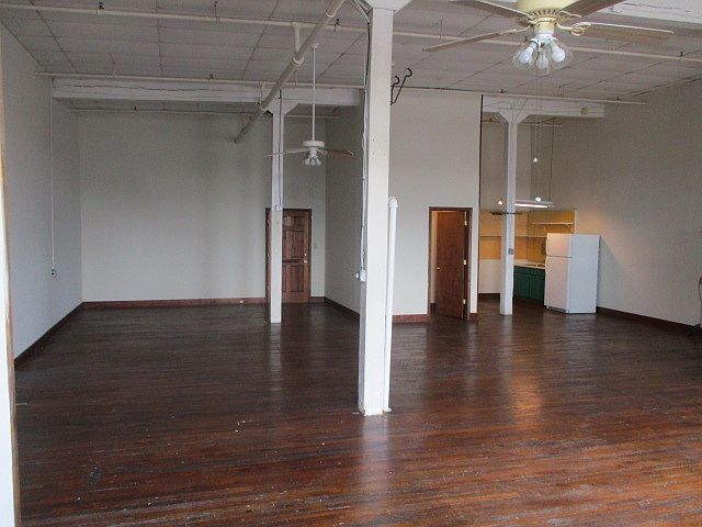 Large studio with high ceilings and windows