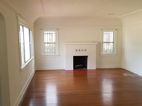 Living room with hardwood floors and gas fireplace.