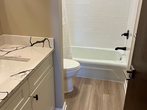 2nd bathroom with granite with quartz counter top and new tile bathroom.