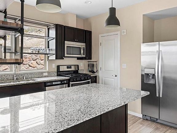 Modern kitchen with granite countertops and upgraded appliances.