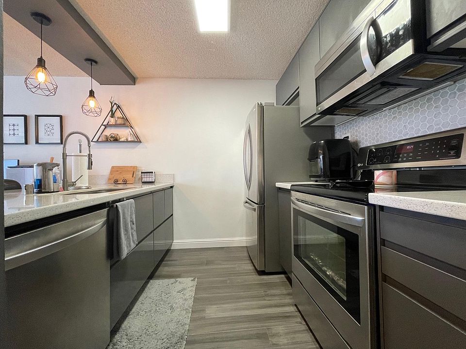 Gally kitchen with soft close cabinets and high-end stainless-steel appliances.