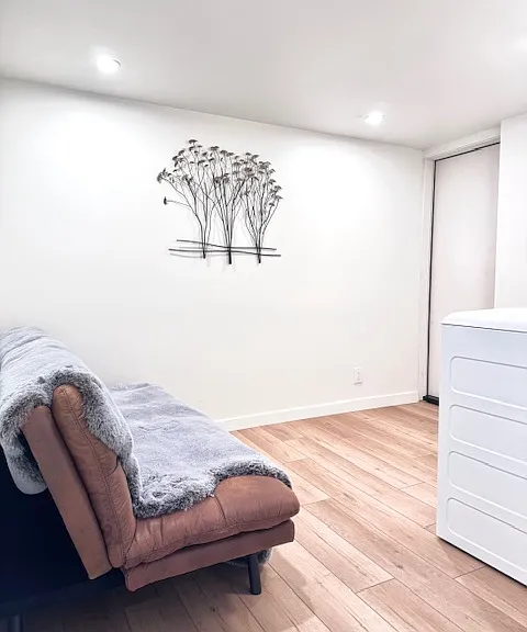 Private entrance. Luxurious seating area with wall art. Brand new washer & dryer.
