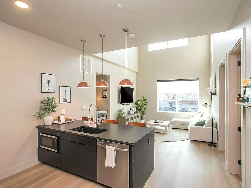 Open concept kitchen + living room with lots of natural light