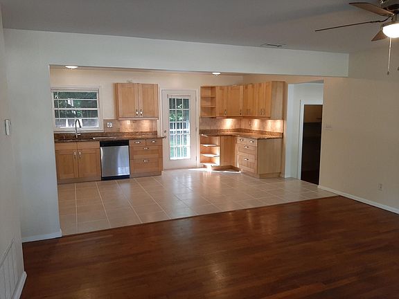 Enter the airy kitchen and open living space.