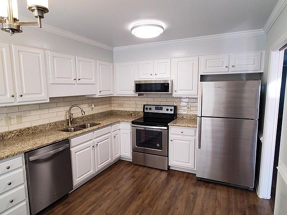 Kitchen with white cabinets, granite counters, new subway stile back splash and new stainless steel appliances (Stove, Dishwasher, Microwave & Fridge)