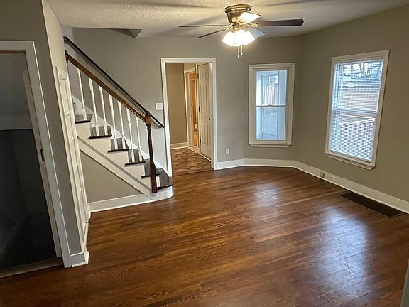 Dining room looking towards kitchen. Door to basement in left of photo. Built in shelf next to stairs