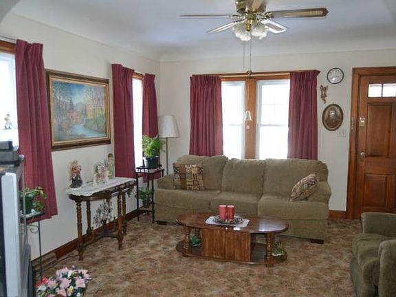The Living room has view of both the front and side yards through the newer windows.  A generous sized room perfect for visiting or just watching TV.