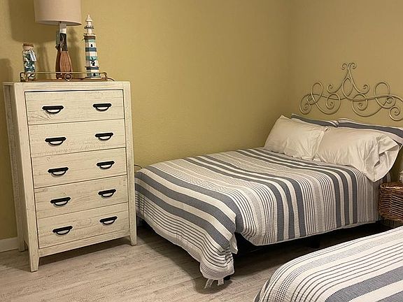 Second bedroom with two full beds and cabinet.