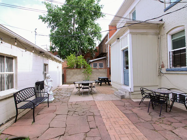 Shared back patio with hanging lights for relaxing, grilling, or entertaining