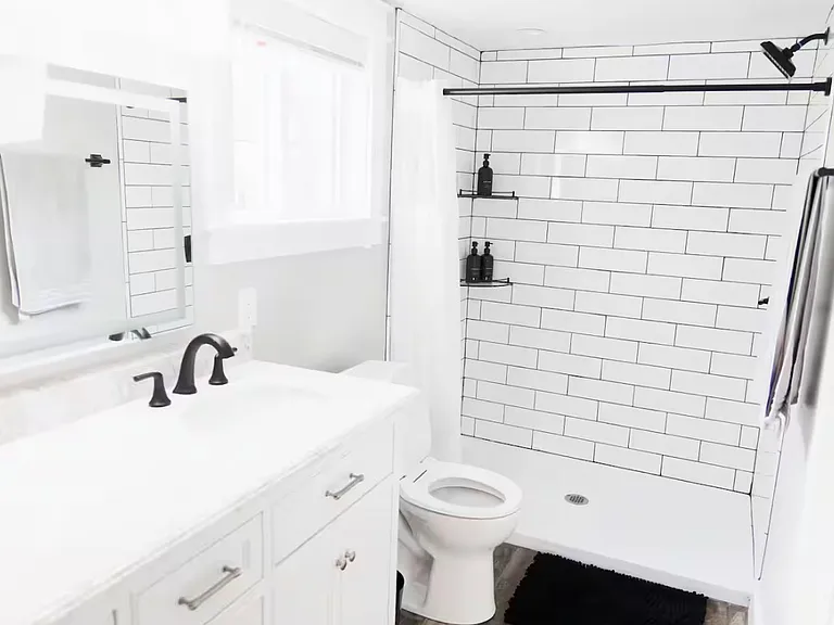 Primary bathroom, includes a walk-in shower, double vanity and washer dryer.