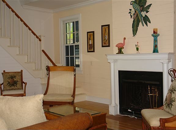 The freshly painted living room features Dade County pine walls and wood floors.