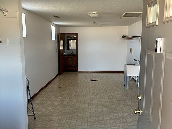 Utility room - photo from entry door. Washer/dryer hook ups. Bathroom rear left. Open coat closet at entry.