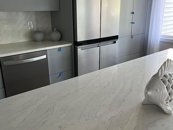Kitchen with quartz counter top and backsplace as well as oversized island.