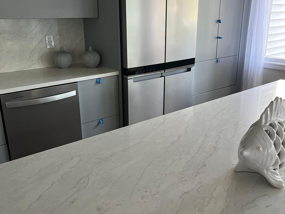 Kitchen with quartz counter top and backsplace as well as oversized island.