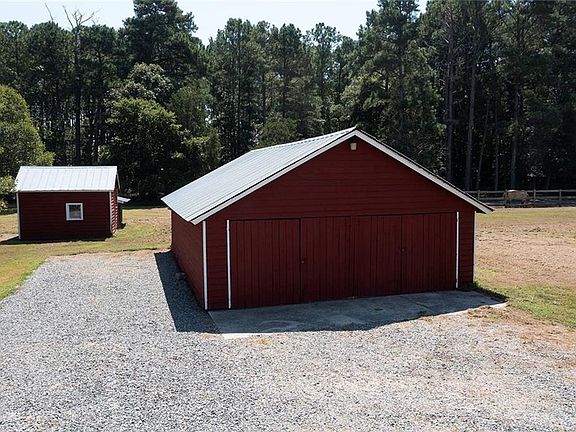 Garage can be used for your vehicle or lawn equipment. A workshop is in the rear of this building.
