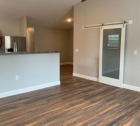 Living room with barn door on storage closet.
