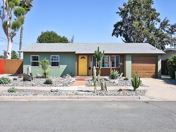Dry-scaped front yard space with various succulents and beach vibes!