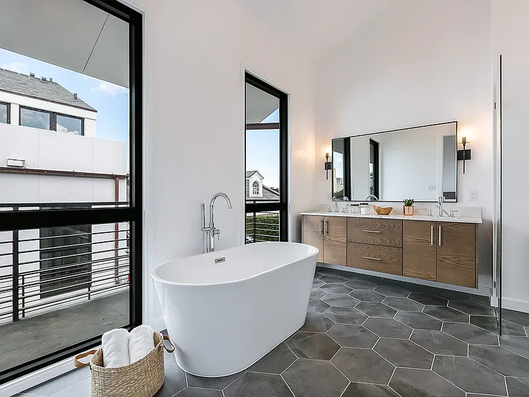 The master bathroom is very spacious and features a free standing bathtub, shower and high end finishes.