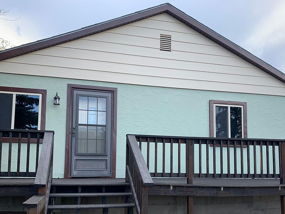 Front street view with deck along entire front of home.
