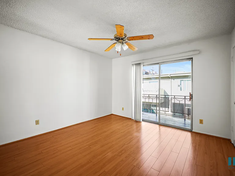 Living Room with a Ceiling Fan, Vinyl Flooring, and Patio