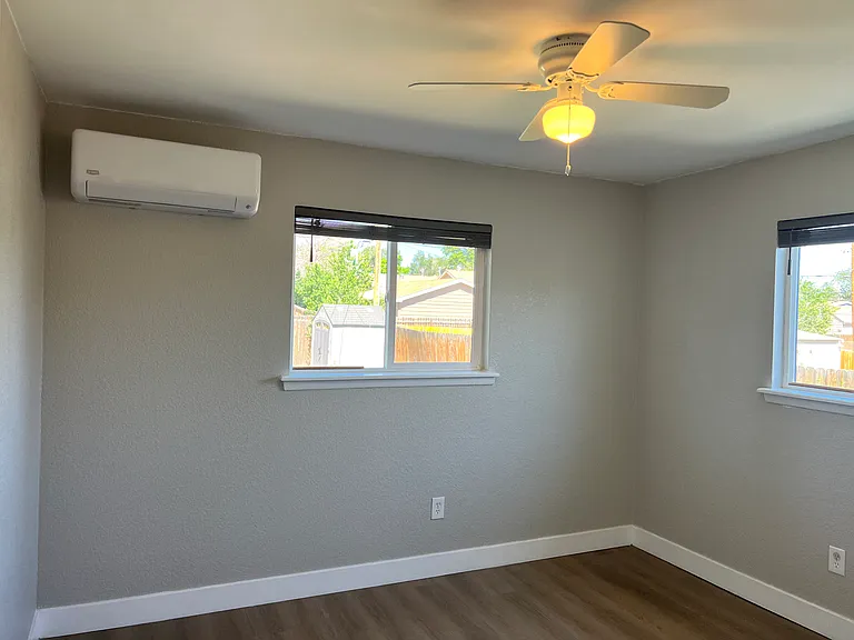 Large, bright 2nd bed with new LVP, fresh paint, faux-wood blinds & dedicated mini-split heating/cooling.