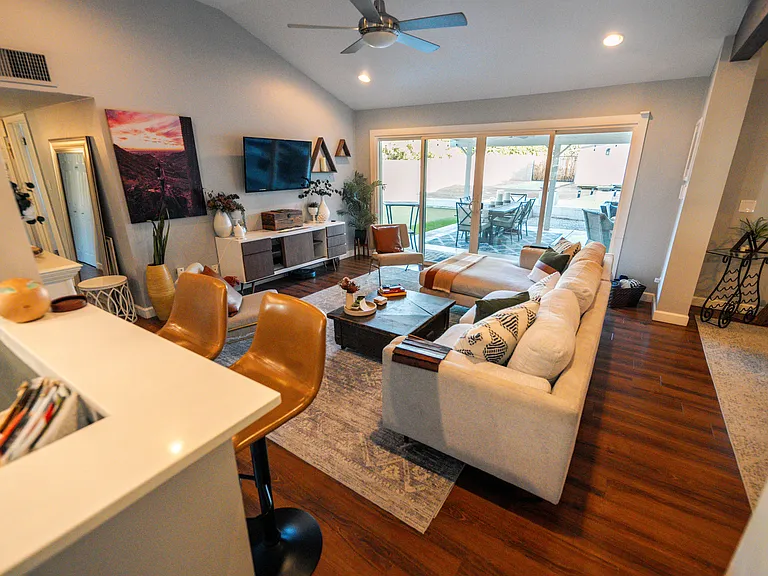 Kitchen looks out to interior living, dining and outside living/dining