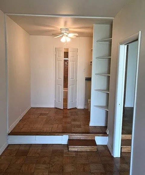 Bedroom and step up to Dressing Area: double door to vanity area on upper level, and sliding door to living room on lower level.
