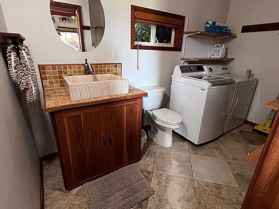 Half bath and laundry room with pantry storage