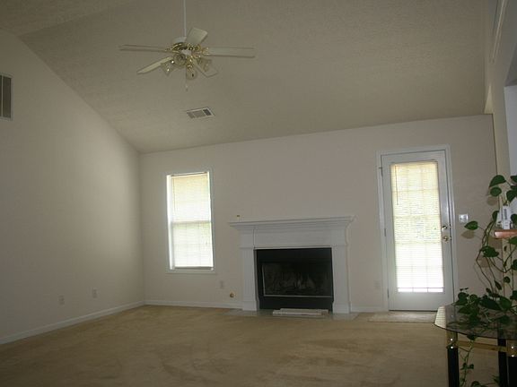 open family room with fireplace and ceiling fan