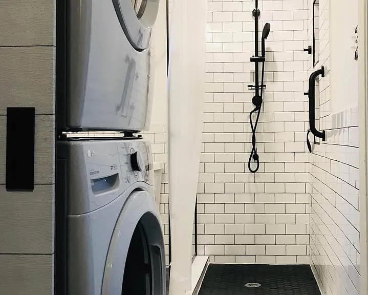 Laundry area and full bathroom with walk-in shower