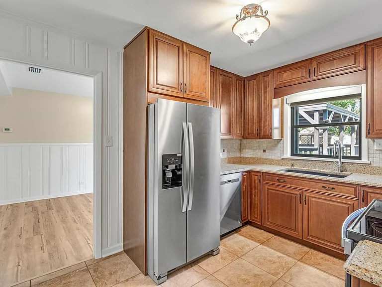 Kitchen with quartz countertops and all new stainless steel appliances.
